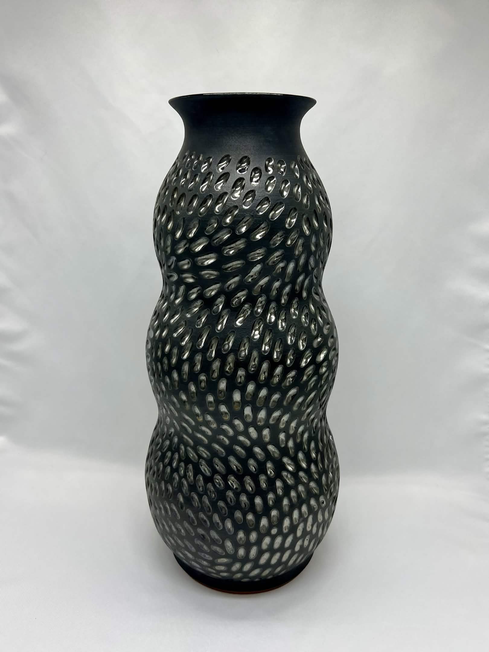 Carved black stoneware vase